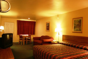 king bed room with sofa bed at Riata Inn Crystal City